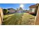 Large backyard with green lawn, privacy fence, mature trees, and sunny exposure at 241 W Atlantic Dr, Casa Grande, AZ 85122