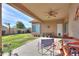 Spacious backyard with covered patio, with chairs and a landscaped lawn, with privacy wall at 241 W Atlantic Dr, Casa Grande, AZ 85122