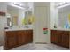Bathroom with a dual-sink vanity featuring a tile counter, well-lit with a clean aesthetic at 241 W Atlantic Dr, Casa Grande, AZ 85122