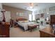 Bedroom featuring a wooden bedframe, full mirror, ceiling fan, and bright natural lighting at 241 W Atlantic Dr, Casa Grande, AZ 85122