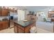 Bright kitchen island with a dark counter-top adjoins the living spaces in this open concept home at 241 W Atlantic Dr, Casa Grande, AZ 85122