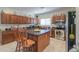 Well-lit kitchen features an island with seating, stainless steel appliances, and abundant cabinet storage at 241 W Atlantic Dr, Casa Grande, AZ 85122