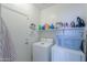 Compact laundry room with shelving for storage, a washer, and a dryer at 241 W Atlantic Dr, Casa Grande, AZ 85122