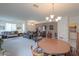 Spacious living area with dining and seating, featuring a large area rug and neutral walls at 241 W Atlantic Dr, Casa Grande, AZ 85122