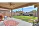 Backyard patio featuring a covered porch with furniture, a lawn and block wall at 241 W Atlantic Dr, Casa Grande, AZ 85122