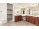 A spacious bathroom with double sinks, vanity, tile floor, and vanity area at 2600 E Hazeltine Way, Chandler, AZ 85249