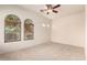 Bright, spacious bedroom with arched windows and neutral carpet, ready for your personal touch at 2600 E Hazeltine Way, Chandler, AZ 85249