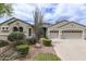 Charming single-story home featuring a well-manicured front yard with desert landscaping and an attached two-car garage at 2600 E Hazeltine Way, Chandler, AZ 85249