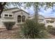 Inviting home featuring arched windows and desert landscaping for a unique curb appeal at 2600 E Hazeltine Way, Chandler, AZ 85249