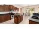 Spacious kitchen boasting dark wood cabinets, stainless steel appliances, and a breakfast nook with backyard views at 2600 E Hazeltine Way, Chandler, AZ 85249