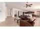 Open-concept living room showcasing tile flooring, an adjacent kitchen, and a seamless flow for modern living at 2600 E Hazeltine Way, Chandler, AZ 85249
