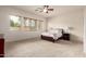 A spacious carpeted main bedroom with three sunny windows at 2600 E Hazeltine Way, Chandler, AZ 85249