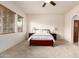 A spacious carpeted main bedroom with two sunny windows at 2600 E Hazeltine Way, Chandler, AZ 85249