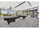 Well-lit billiard room with expansive windows and modern decor, providing a relaxing space at 27196 N 129Th Dr, Peoria, AZ 85383