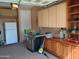 Spacious garage with ample storage cabinets, workbench area, and room for tools and equipment at 27196 N 129Th Dr, Peoria, AZ 85383