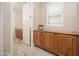 Hallway features custom cabinetry with glass counters at 27196 N 129Th Dr, Peoria, AZ 85383