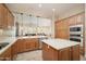 Updated kitchen boasts an island, stainless appliances, and plenty of cabinet and counter space at 27196 N 129Th Dr, Peoria, AZ 85383