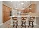 Spacious kitchen features stainless appliances, breakfast bar with seating, and warm wood cabinets at 27196 N 129Th Dr, Peoria, AZ 85383