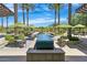 Charming outdoor dining area with umbrellas and a decorative water feature, creating a serene atmosphere at 27196 N 129Th Dr, Peoria, AZ 85383