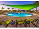 Stunning community pool with colorful shade structures and poolside seating, offering a resort-style leisure experience at 27196 N 129Th Dr, Peoria, AZ 85383