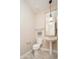 Charming powder room with a pedestal sink, decorative mirror, and classic fixtures at 27196 N 129Th Dr, Peoria, AZ 85383