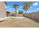 Backyard with ample space, block fencing, and mature trees providing shade at 2859 E Cathy Dr, Gilbert, AZ 85296