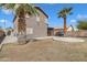 Wide backyard showcasing mature palms, an outdoor dining area, and gravel throughout at 2859 E Cathy Dr, Gilbert, AZ 85296