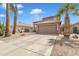 Inviting two-story home featuring desert landscaping, mature palm trees and a two car garage at 2859 E Cathy Dr, Gilbert, AZ 85296
