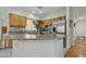 Bright kitchen with wooden cabinetry, stainless steel appliances, and an island with counter seating at 2859 E Cathy Dr, Gilbert, AZ 85296