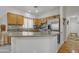 Bright kitchen with wooden cabinetry, stainless steel appliances, and an island with counter seating at 2859 E Cathy Dr, Gilbert, AZ 85296