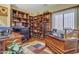 Bright office with custom wooden built-in bookshelves, paired with two desks and a large window for natural light at 2859 E Cathy Dr, Gilbert, AZ 85296