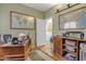 Inviting home office with wooden desk, world maps, and an abundance of natural light at 2859 E Cathy Dr, Gilbert, AZ 85296