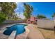 Backyard with a sparkling pool, diving board, patio area, and lush green grass at 2942 E Mulberry Dr, Phoenix, AZ 85016