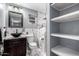 Elegant bathroom boasts marble walls, vessel sink, and open shelving for storage at 2942 E Mulberry Dr, Phoenix, AZ 85016