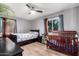 Cozy bedroom with wood floors, ceiling fan, and two bright windows for natural light at 2942 E Mulberry Dr, Phoenix, AZ 85016