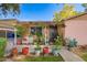 Inviting front entrance with decorative plants, a cozy bench, and a detailed door, perfect for welcoming guests at 2942 E Mulberry Dr, Phoenix, AZ 85016