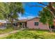 A cozy home with a well-manicured lawn, mature trees, and a covered carport, creating a welcoming curb appeal at 2942 E Mulberry Dr, Phoenix, AZ 85016