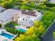 Stunning aerial view of the home with a pool, covered patio, trampoline, and solar panels on the roof at 2973 E Austin Dr, Gilbert, AZ 85296