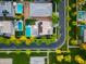 An aerial view of a neighborhood showcasing a beautiful home with a pool, solar panels, and lush greenery at 2973 E Austin Dr, Gilbert, AZ 85296