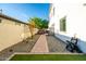 Low-maintenance backyard with gravel, grass, paved path, storage shed, and privacy wall at 2973 E Austin Dr, Gilbert, AZ 85296
