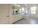 Bright bathroom with a large mirror, double vanity, soaking tub, and tile flooring at 2973 E Austin Dr, Gilbert, AZ 85296