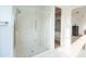 Modern bathroom featuring a glass-enclosed shower and sleek white tile flooring at 2973 E Austin Dr, Gilbert, AZ 85296