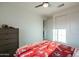 Bright bedroom features a ceiling fan, a window, a dresser and a comfortable bed at 2973 E Austin Dr, Gilbert, AZ 85296