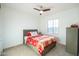 Bright bedroom features a ceiling fan, a window, and a comfortable bed at 2973 E Austin Dr, Gilbert, AZ 85296