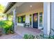 Inviting covered porch with seating, decorative door wreath, and stylish accents, offering a welcoming entrance at 2973 E Austin Dr, Gilbert, AZ 85296