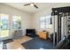Bright exercise area with rubber flooring, weight machines, and natural light from backyard-facing windows at 2973 E Austin Dr, Gilbert, AZ 85296