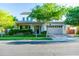 Charming two-story home featuring a well-manicured lawn, mature trees, and an inviting covered porch at 2973 E Austin Dr, Gilbert, AZ 85296