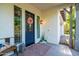 Inviting front porch with a blue door, a wreath, a bench, and decorative plants creating a warm welcome at 2973 E Austin Dr, Gilbert, AZ 85296
