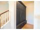 Hallway with floor-to-ceiling cabinets, bench, and hardwood floors near the staircase at 2973 E Austin Dr, Gilbert, AZ 85296