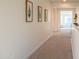 Neutral hallway with a carpet, light walls and decorated with framed artwork at 2973 E Austin Dr, Gilbert, AZ 85296
